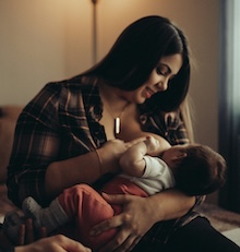 A mother breastfeeding a baby