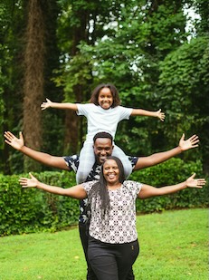 Three people with their arms outstretched